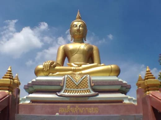 Large seated golden Buddha pictured in the trip brochure